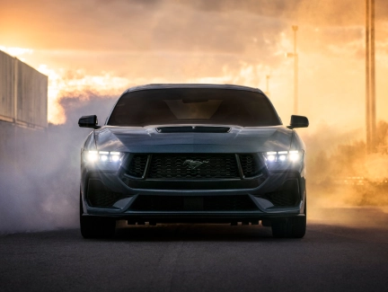 Close-up front view of a Mustang, emphasizing the aggressive grille and headlight design.