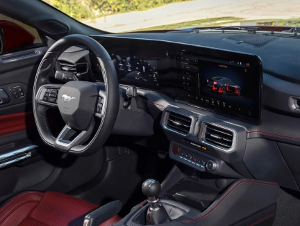 Interior view of the Ford Mustang, focusing on the driver's seat and dashboard, showcasing the innovative technology and modern design.