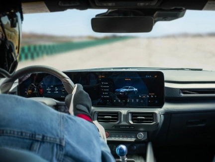 Driver's perspective of the Ford Mustang's digital instrument cluster displaying performance tracking data, highlighting the real-time performance monitoring capabilities.